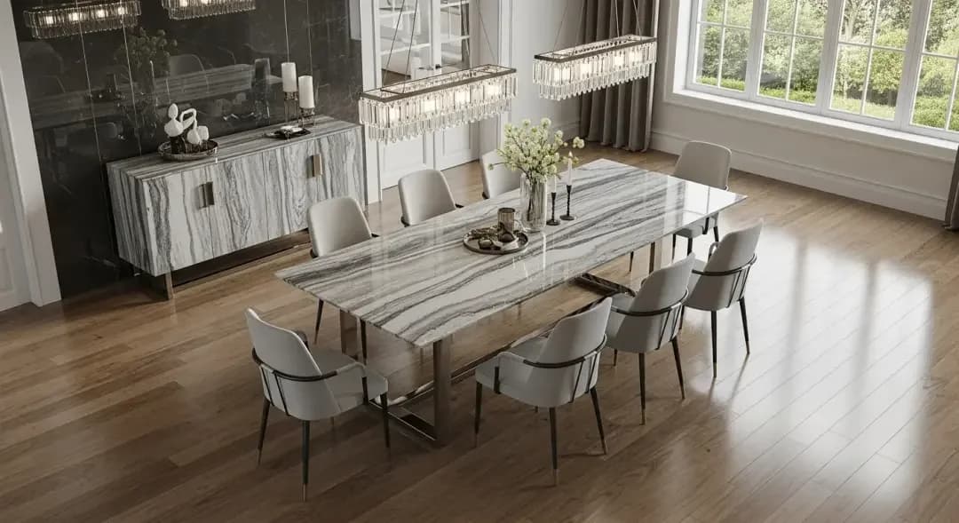 Dining room inspiration with a long stone table, upholstered seating and pendant lighting