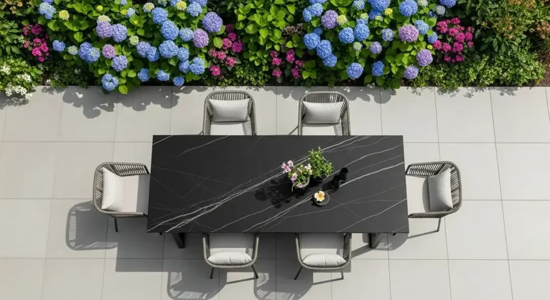 Outdoor dining inspiration with a dark rectangular table and upholstered chairs