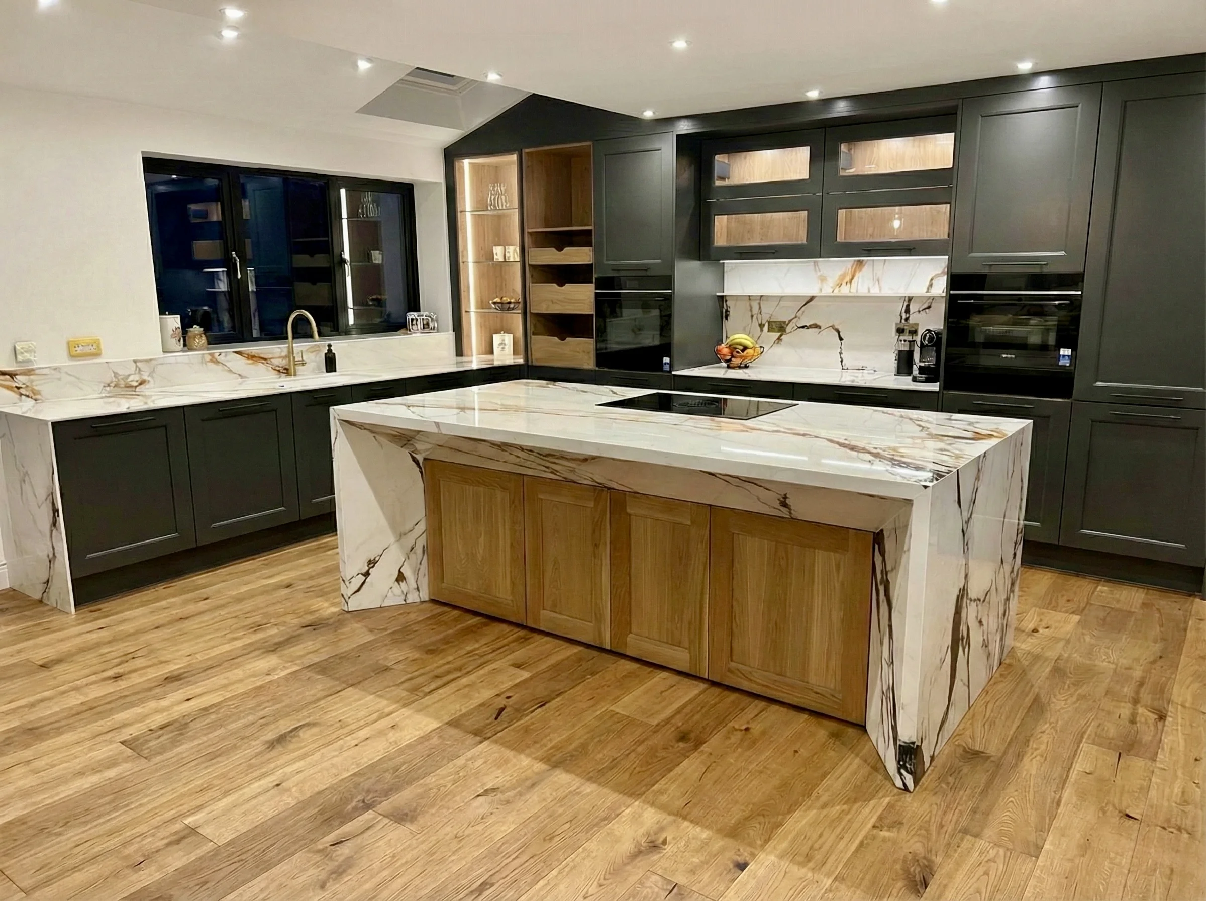 Dark Kitchen with Marble Veined Island